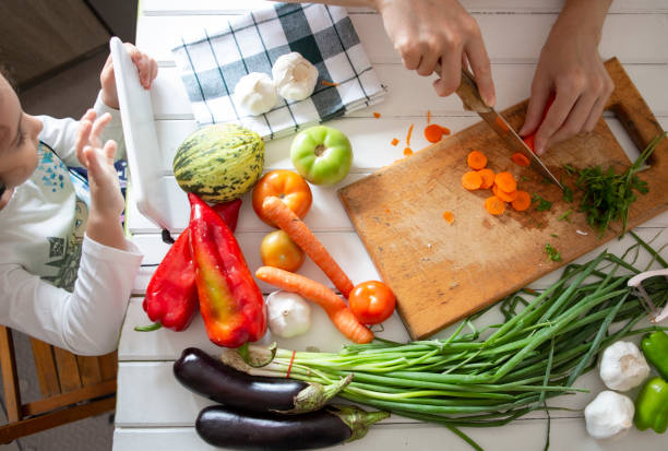 istock Mommy and daughter at kitchen 1294606372