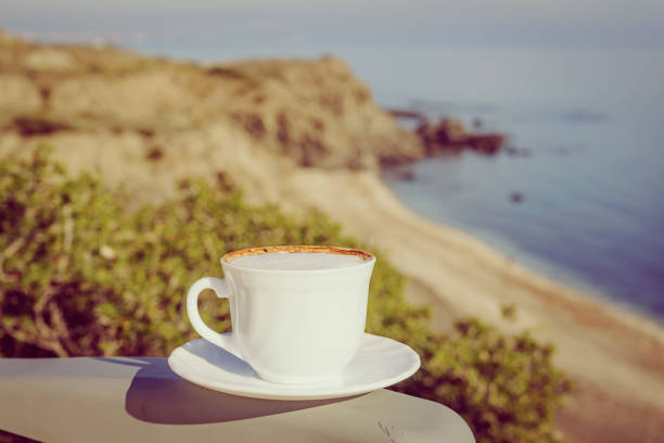 istock Coffe cup against sea beach. 1294607545