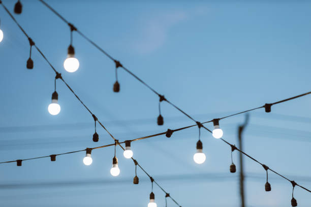 istock Light bulb decor on blue sky in the outdoor party. 1294609060
