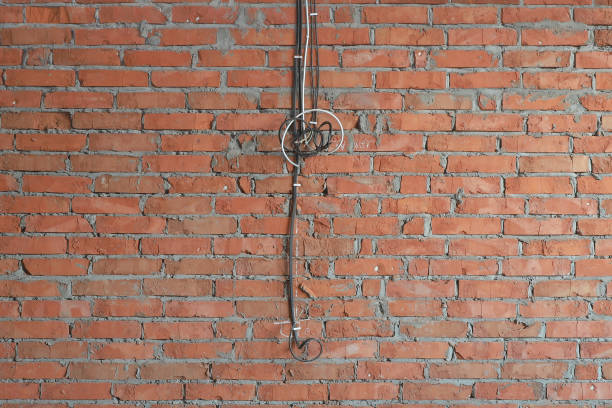 istock several electrical cables on a brick wall for the installation of future outlets in the house under construction 1294611785
