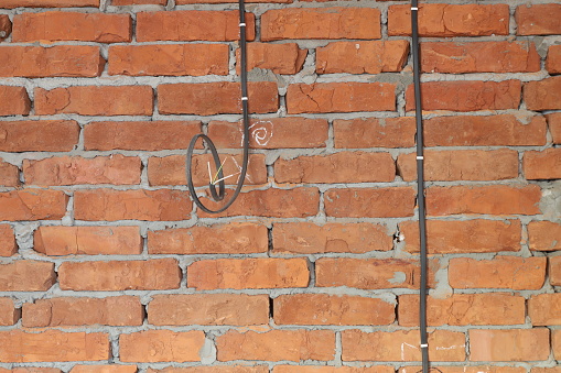 electric cable installed on the brick wall of a new house under construction background image without people close up brickwork cement