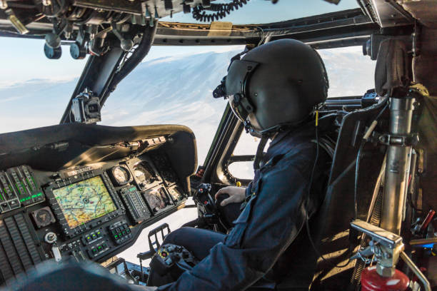 istock Army pilot riding military helicopter 1294611870
