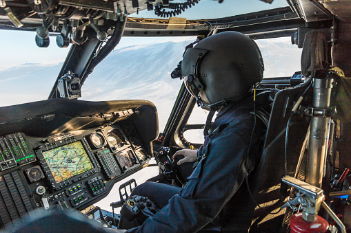 Army pilot riding military helicopter