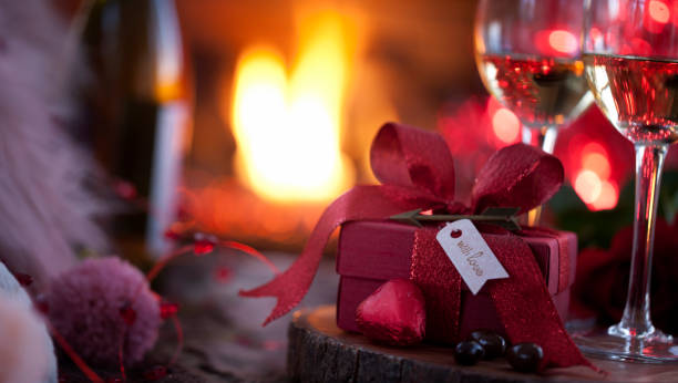 istock Valentine's Day Gift and White Wine in front of the Fireplace 1294612051