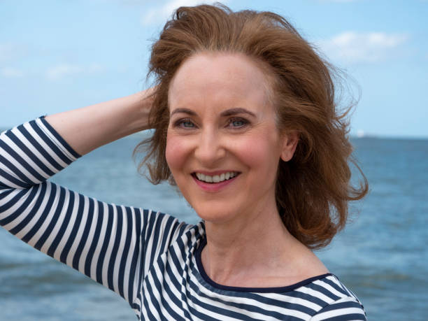 istock Serious mature woman at beach. 1294612173