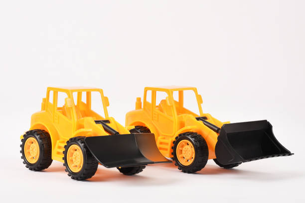 istock Toy bulldozer construction vehicles on the white background 1294616126