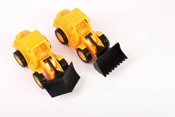 Toy bulldozer construction vehicles on the white background