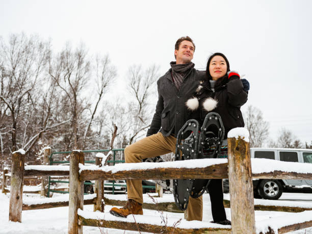 istock Mixed race couple snowshoeing in winter 1294618402