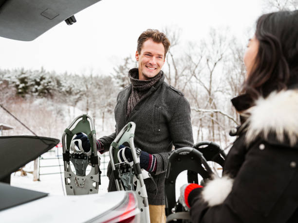 istock Mixed race couple unloading car in winter 1294618429