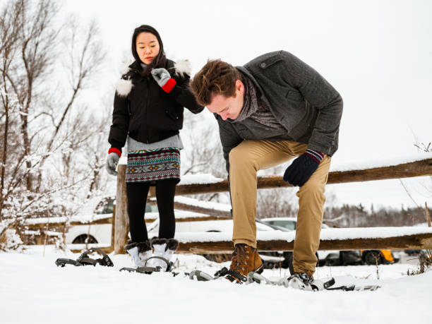 istock Mixed race couple snowshoeing in winter 1294618640