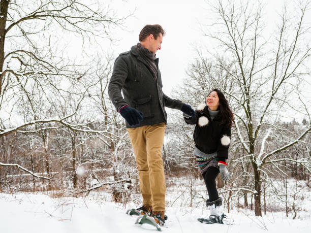 istock Mixed race couple snowshoeing in winter 1294618710