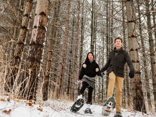 istock Mixed race couple snowshoeing in winter 1294619325