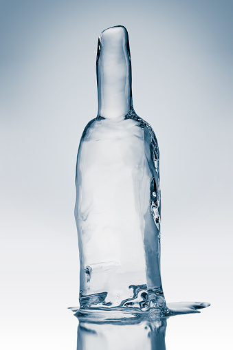 Bottle form, made from clean, transparent ice. Purity and freshness concept.