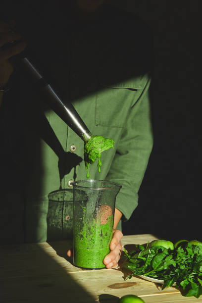 istock Process of preparing green detox smoothie with blender 1294627353