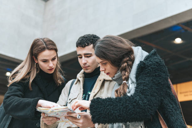 istock three young tourists looking at city map in Berlin subway station 1294628107