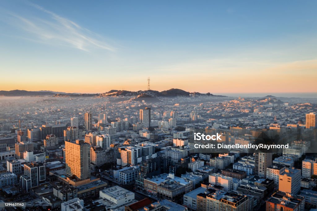 Aerial View of Fog Over San Francisco Skyline Aerial view of golden sunrise with fog over the city San Francisco looking at Sutro Tower. San Francisco - California Stock Photo