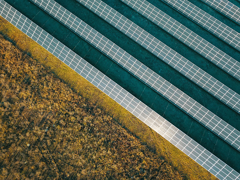 Aerial view of a solar farm producing clean renewable sun energy, industrial landscape