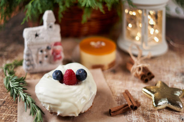 istock Cake decorated with blackberries and raspberries on the christmas table, close up 1294634531