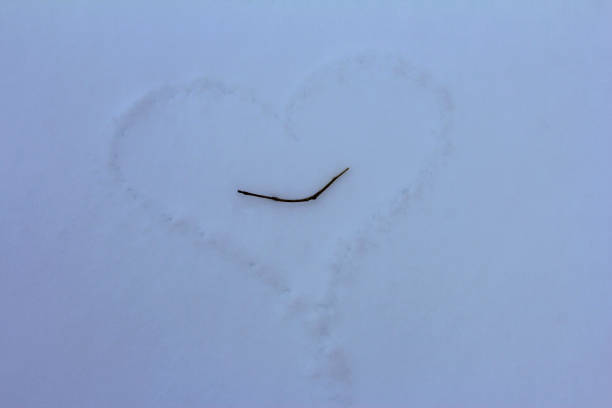 istock A heart drawn in the snow. Love symbol on a snowdrift. 1294636504