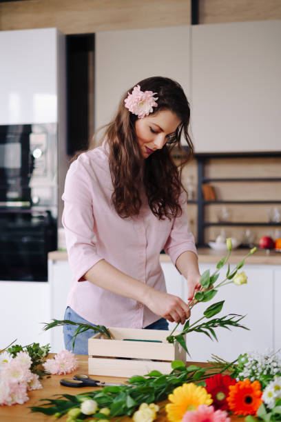 istock Beautiful florist arranging a flower composition 1294636763