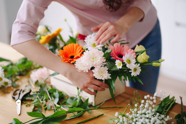 istock Beautiful florist hands arranging a flower composition 1294636775