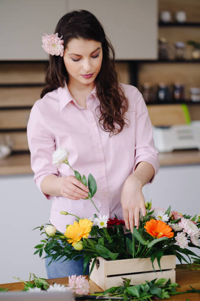 istock Beautiful florist arranging a flower composition 1294636793