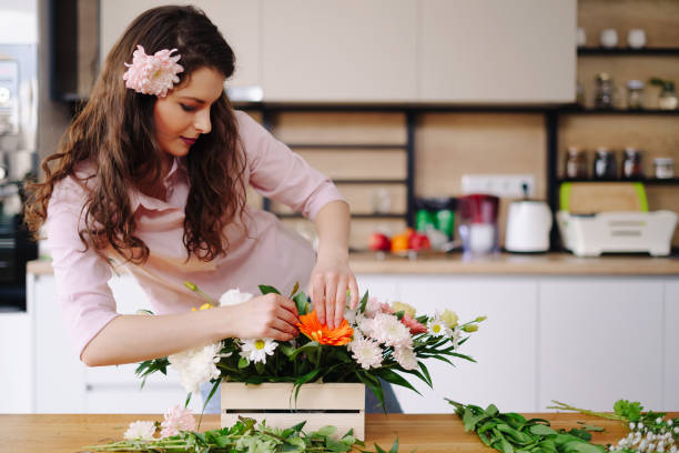 istock Beautiful florist arranging a flower composition 1294636799