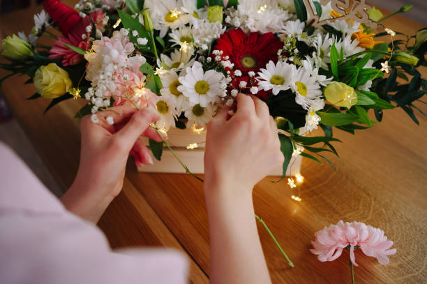 istock Beautiful florist arranging a flower composition 1294636840