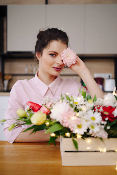 istock Beautiful florist arranging a flower composition 1294636843