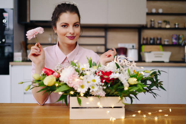istock Beautiful florist arranging a flower composition 1294636845