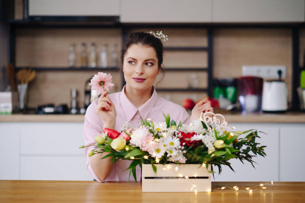 istock Beautiful florist arranging a flower composition 1294636848
