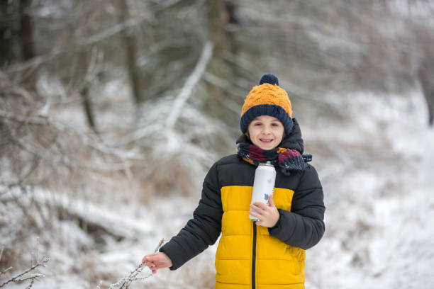 istock Cute child, playing in winter forest on a cold winter day 1294637301