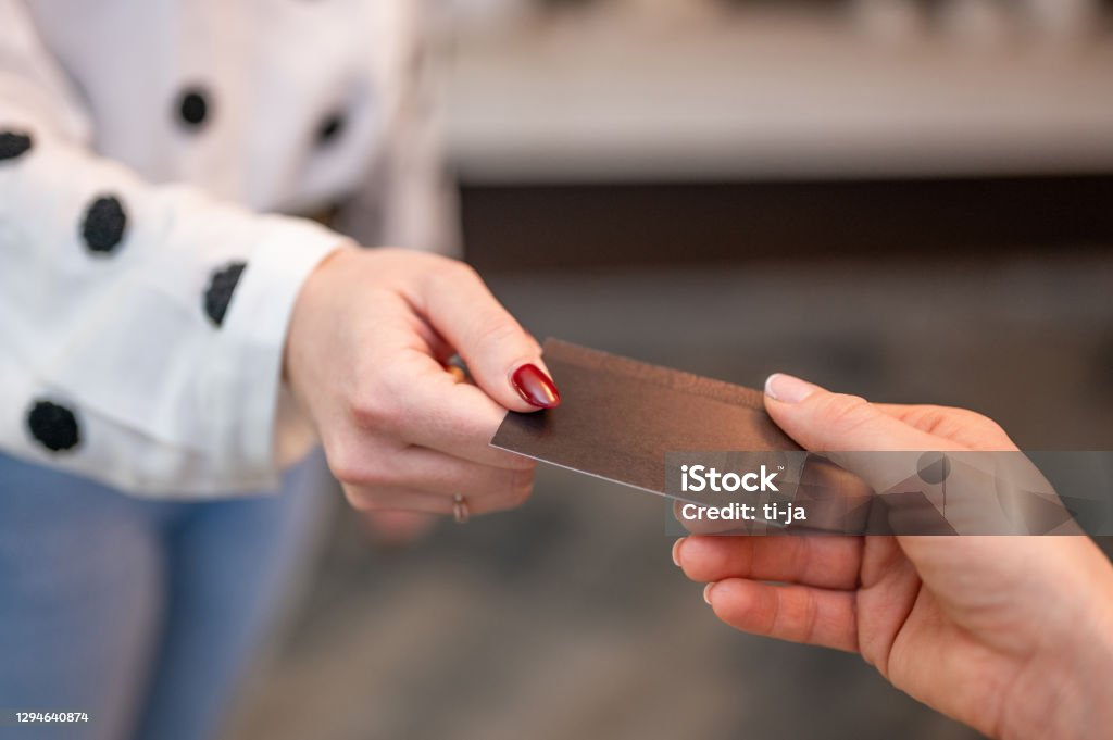 Hands passing a blank business card Female's hands passing a blank business card. Business Card Stock Photo