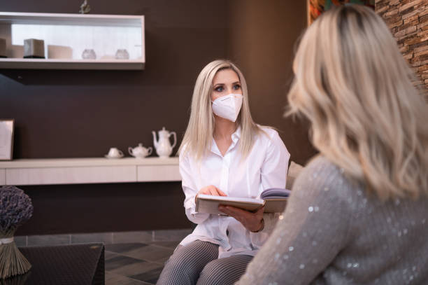 istock Two women with protective face mask on the meeting 1294641048