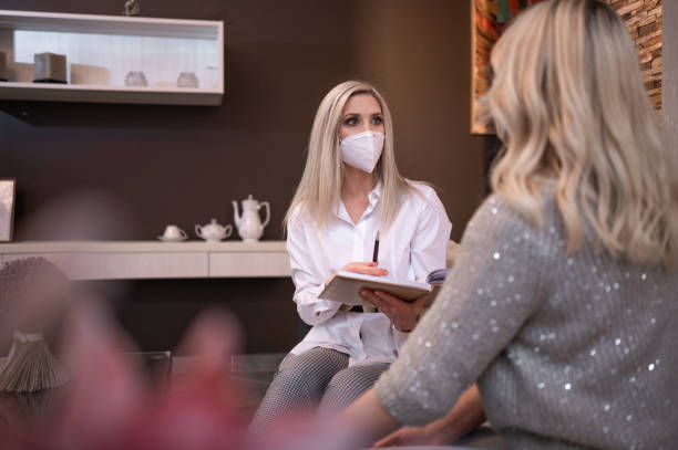 istock Two women with protective face mask on the meeting 1294641143