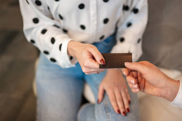 istock Hands passing a blank business card 1294641229