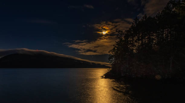 istock Moonlight on Clouds, Fog and Dark Water 1294642397