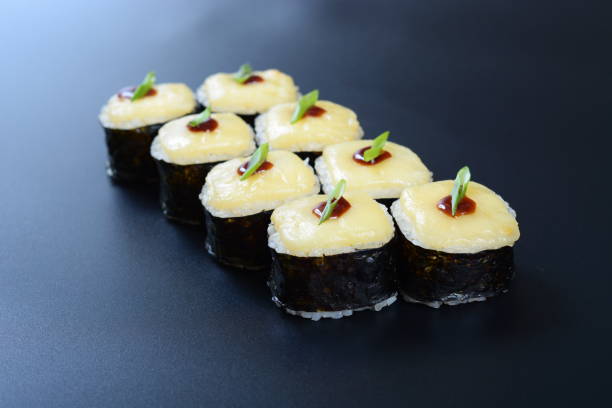 istock Colorful rolls with seafood and rice lie on a dark stone background 1294642914