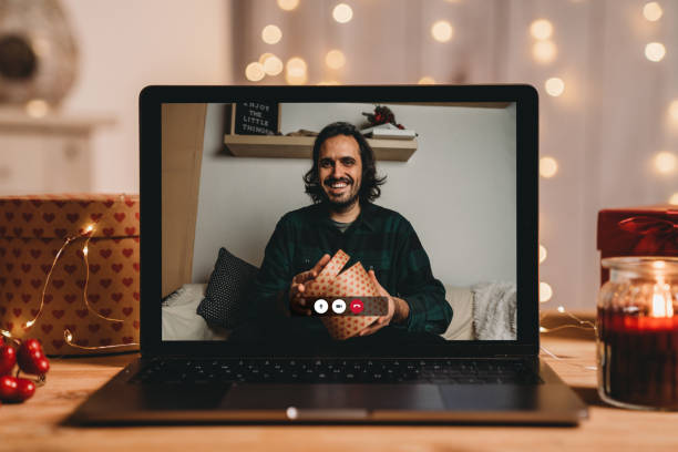 istock Young man opening a present for Valentine's day during a videocall 1294643052
