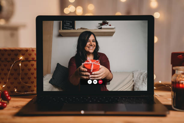 istock Young woman giving a present for Valentine's day during a videocall 1294643055