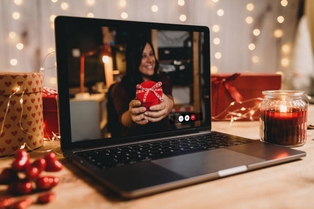 istock Young woman giving a present for Valentine's day during a videocall 1294643088
