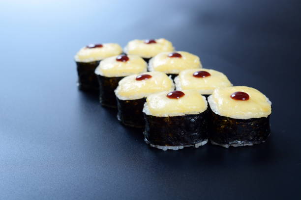 istock Colorful rolls with seafood and rice lie on a dark stone background 1294643242