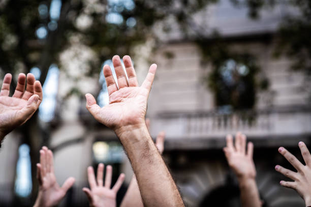 istock Hands raised in the air asking for freedom. Stop racism. Stop repression. 1294644403