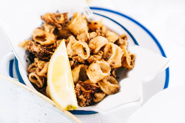 istock Fried squid on a plate with lemon in a restaurant. Typical recipe from Spain. 