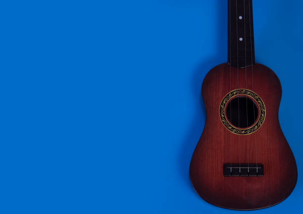 istock Acoustic guitar on a blue background. Musical instrument. 1294646594