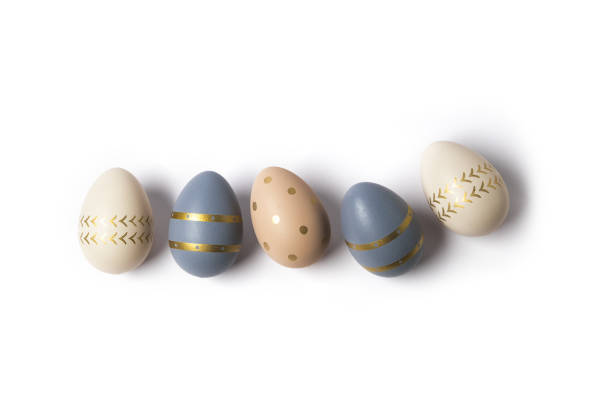 istock Decorated eggs stand in a row on white background 1294647494
