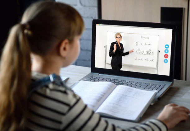 istock Schoolgirl and teacher learn a physics lesson using video chat on laptop. Video conference with the tutor at home. Online distance education. 1294653298