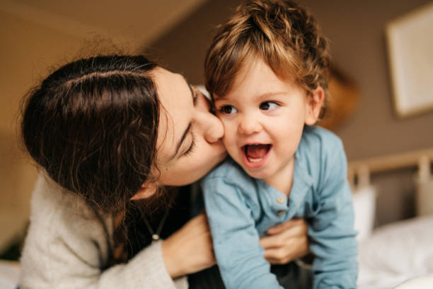 istock Little boy and mother lying on bed 1294654640
