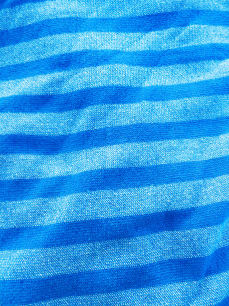 istock Blue striped towel texture. Summery background. Summer beach towel. 1294656794