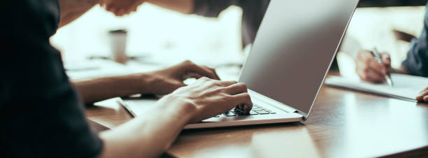istock close up. image of a man working on an office laptop 1294656958